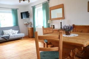 a dining room and living room with a wooden table at Fuchsheisl in Riedenburg