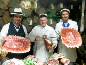 a group of three chefs standing in front of meat at Il Merlo Verde in Monteverdi Marittimo