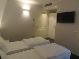 Voodi või voodid majutusasutuse Albergo Dongo toas