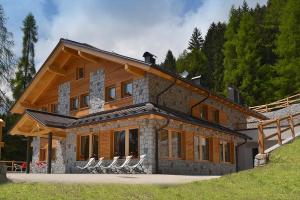 a large house with chairs in front of it at Chalet Serena in Roncegno