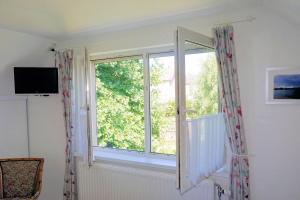 a window in a room with a curtain at Droomzzz in Herkenbosch