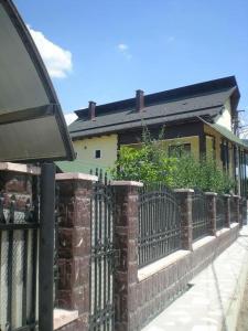 a brick fence in front of a house at Pensiunea La Răducu in Vişeu de Sus