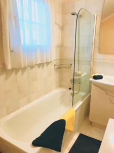 a bathroom with a bath tub and a sink at Rocas del Mar in Costa Del Silencio +13 photos