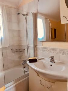 a bathroom with a sink and a shower at Rocas del Mar in Costa Del Silencio