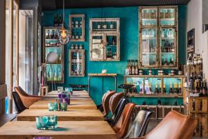 a long table in a room with a green wall at Hotel - Weinbar FAHR AWAY in Volkach