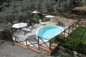 an image of a swimming pool with umbrellas at Agriturismo Il Calesse in Quarrata