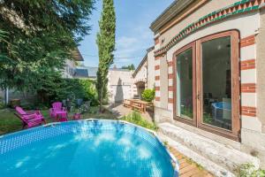 a swimming pool in the backyard of a house at La Closerie des Hauts de Loire in Montlouis-sur-Loire