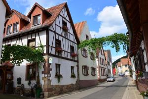 a street in a medieval town with white buildings at Gästehaus Ehrhardt in Schweigen-Rechtenbach