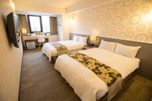 Postel nebo postele na pokoji v ubytování Ximen Relite Hotel
