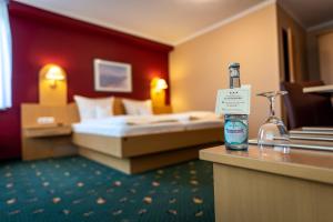 a hotel room with a bottle of water on a counter at Komfort-Hotel Katerberg in Lüchow