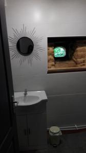 a bathroom with a sink and a mirror on the wall at Au Tilleul in Archignac +19 photos