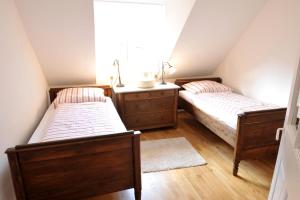 Llit o llits en una habitació de Ferienhaus Gehöschnes mit kostenfreien ÖPNV-Ticket
