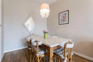 a dining room table with chairs and a chandelier at St Patricks Cathedral Self Catering in Dublin