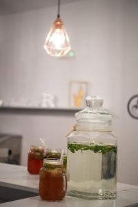 a glass jar on a counter with jars of sauce at Akroyiali Resort in Vasiliki