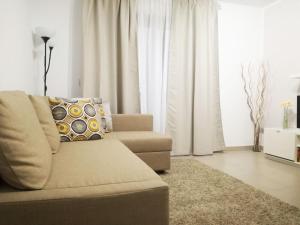 a living room with a couch and white curtains at Janias Alcalà Apartment in Alcalá