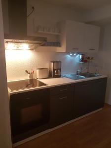 a kitchen with a sink and a counter top at Ferienwohnung im Mühlbachtal in Miehlen