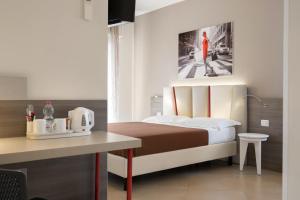 a bedroom with a bed and a table with a table at Guesthouse Verona in Verona