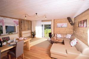 a living room with a couch and a table at Traumhafte Ferienwohnungen im Naturpark Zittauer Gebirge Haus Tanneck in Hain