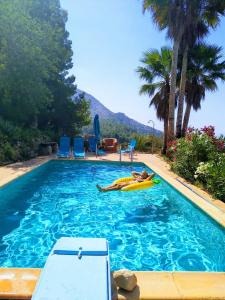 una persona tumbada en una balsa en una piscina en casa India, en Alicante