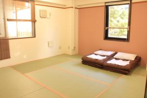 Un ou plusieurs lits dans un hébergement de l'établissement T and K Hostel Kobe Sannomiya East