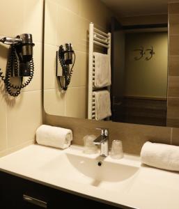 a bathroom with a sink and a mirror at Hotel Edelweiss in Courchevel
