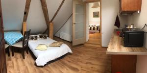 a bedroom with a bed and a table and a staircase at A1 apartments with free parking in Rīga