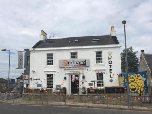 a white building on the corner of a street at The Orchard Hotel in Falkirk +23 photos