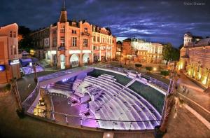 a large amphitheater in a city at night at Studio M in Plovdiv