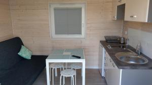 a small kitchen with a sink and a counter at Kamień Bałtyku Rowy in Rowy