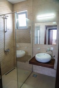 a bathroom with a sink and a glass shower at La Dolce Vita Residence in Ulcinj