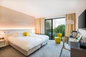 a hotel room with a bed and a desk at BW Premier Collection Le Saint Antoine Hotel et Spa in Rennes +43 photos