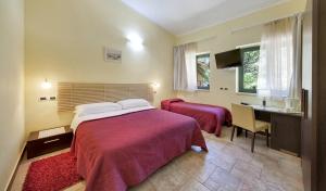 a hotel room with a bed and a desk and a desk at Casale Romano Resort e Relais in Motta Camastra +67 photos