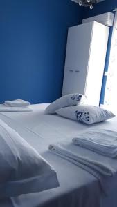 a bed with white sheets and pillows on it at AD in Capo dʼOrlando