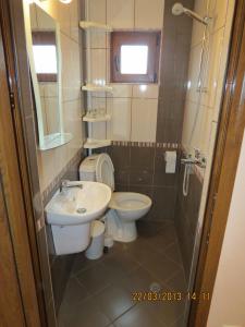 a bathroom with a toilet and a sink at Family Hotel Lebed in Nesebar