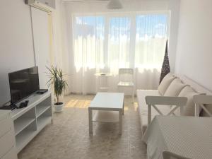 a living room with a couch and a table and a tv at El MATE apartment Sea Garden and Beach Varna in Varna City