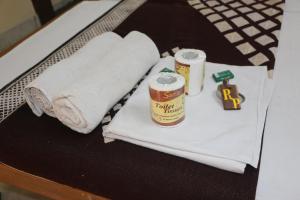 a table with towels and a can of beer on it at Hotel Renuka in Jaisalmer