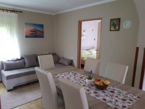 a dining room with a table and a couch at Apartman Anna in Ogulin
