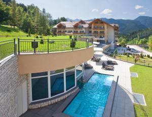 a view of a resort with a swimming pool at Rio Stava Family Resort & Spa in Tesero