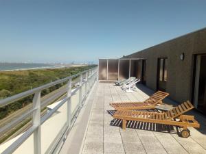a balcony with chairs and a view of the ocean at Penthouse Poseidon in Blankenberge