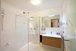 a bathroom with a shower and a sink at Rio Stava Family Resort & Spa in Tesero