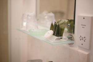 a glass shelf on a wall with pens on it at Birchleigh Guest House in Grange Over Sands