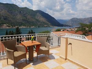 a balcony with a table and chairs and a view at Apartments Peranovic 2 in Kotor