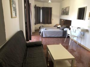 Posteľ alebo postele v izbe v ubytovaní Hostal Tamonante