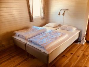 two twin beds in a room with a window at Doro Camp Lapland in Dorotea