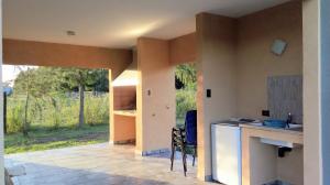 a kitchen with a counter and a table and chairs at Dreams Rest in Gualeguaychú