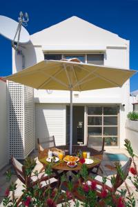 a table with an umbrella and a table cloth at Casa Maistra Residence in Rethymno