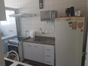 a small kitchen with a sink and a refrigerator at São Paulo Expo 3KM /Aeroporto 7KM in São Paulo