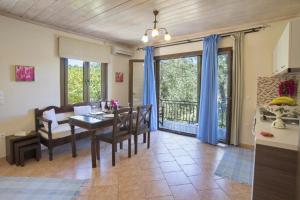 a kitchen and dining room with a table and chairs at Eftihia cottage in Longós