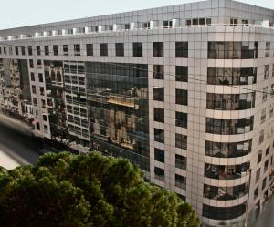 a tall white building with lots of windows at Doubletree By Hilton Buenos Aires in Buenos Aires