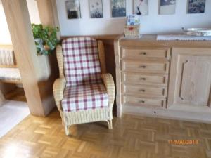 a living room with a chair and a dresser at Ferienwohnung Soyer in Sonthofen